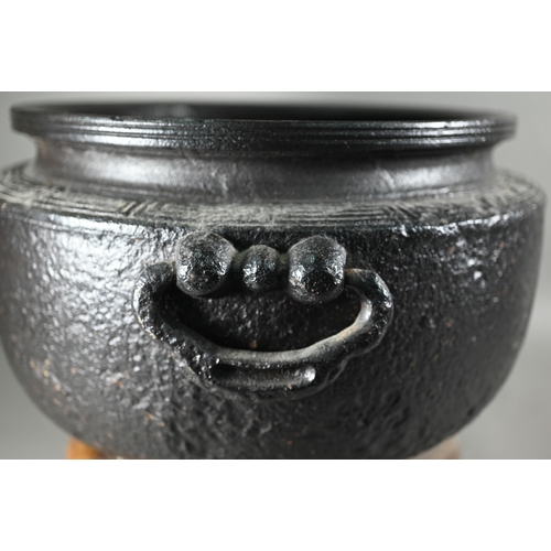 377 - A large Japanese cast iron tripod hibachi (traditional brazier) cast with key-fret thunder pattern b... 