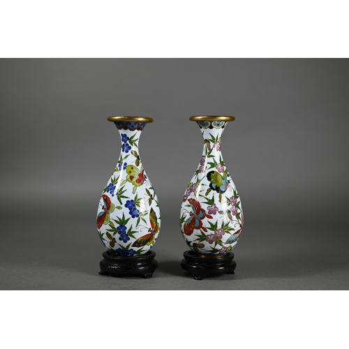 378 - A pair of Japanese cloisonne vases decorated with butterflies and flowers in polychrome enamels on w... 