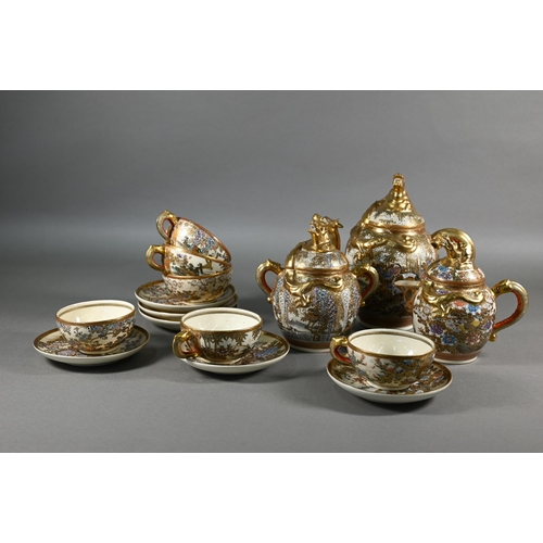 379 - A Japanese Satsuma tea service by Hododa, comprising teapot, milk jug and sugar bowl all with covers... 