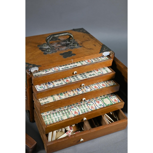 381 - A Chinese Mah Jong set, the carved wooden and brass mounted case with two carry handles and sliding ... 