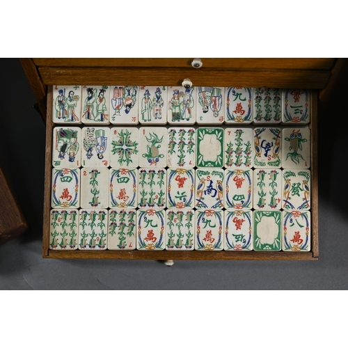 381 - A Chinese Mah Jong set, the carved wooden and brass mounted case with two carry handles and sliding ... 