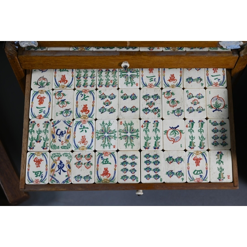 381 - A Chinese Mah Jong set, the carved wooden and brass mounted case with two carry handles and sliding ... 