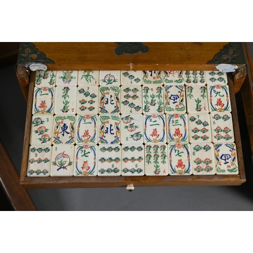 381 - A Chinese Mah Jong set, the carved wooden and brass mounted case with two carry handles and sliding ... 