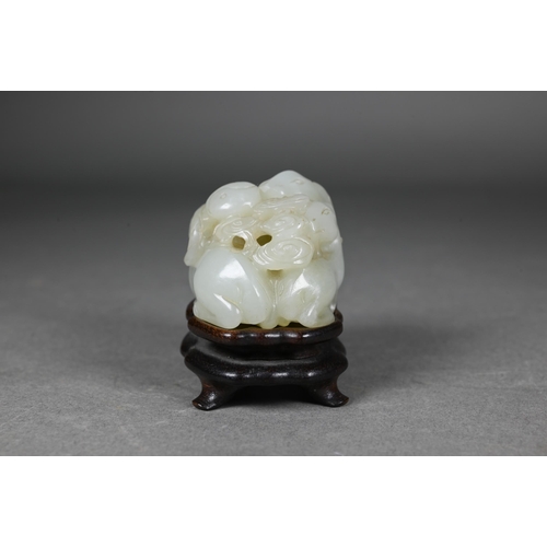 383 - An 18th century Chinese jade carving of three rams, sanyang, with swirling clouds and a yinyang symb... 