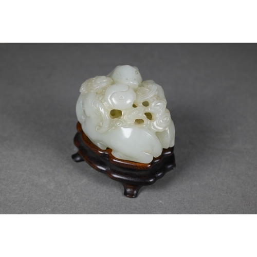 383 - An 18th century Chinese jade carving of three rams, sanyang, with swirling clouds and a yinyang symb... 