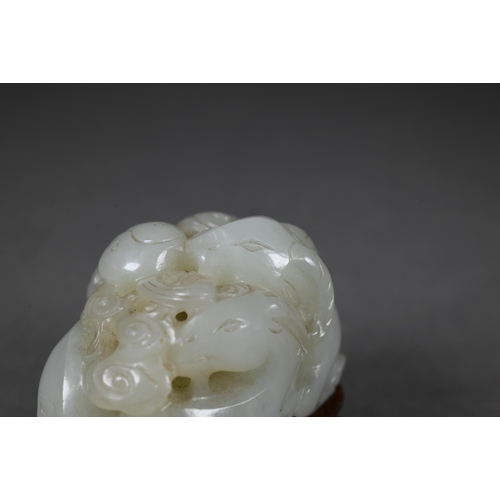 383 - An 18th century Chinese jade carving of three rams, sanyang, with swirling clouds and a yinyang symb... 