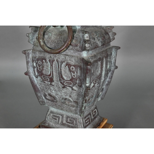 389 - A Chinese bronze archaistic fang hu form ritual wine vessel with loose ring handles, cast with taoti... 