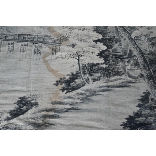 391 - An early 20th century Japanese textile wall hanging, ink on fabric landscape with long wooden pedest... 