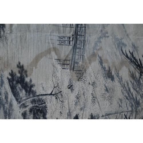 391 - An early 20th century Japanese textile wall hanging, ink on fabric landscape with long wooden pedest... 