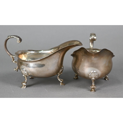 42 - A pair of silver sauce boats with scroll handles and hoof feet, William Comyns & Sons Ltd., Lond... 