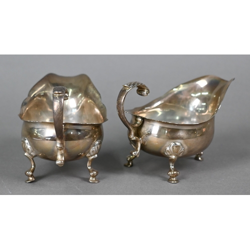 42 - A pair of silver sauce boats with scroll handles and hoof feet, William Comyns & Sons Ltd., Lond... 