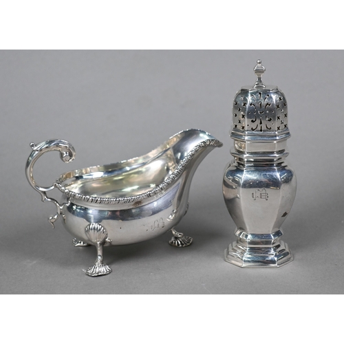 47 - An Edwardian silver pot-bellied cream boat in the Georgian manner, with gadrooned rim, scroll handle... 