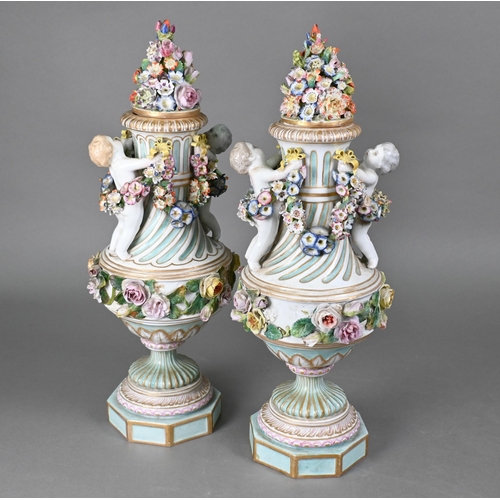 489 - A pair of 19th century Meissen garniture vases, with floral-encrusted covers above twin putti handle... 