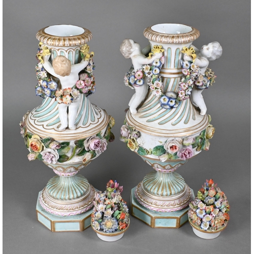 489 - A pair of 19th century Meissen garniture vases, with floral-encrusted covers above twin putti handle... 