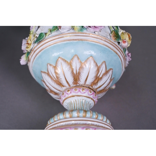 489 - A pair of 19th century Meissen garniture vases, with floral-encrusted covers above twin putti handle... 