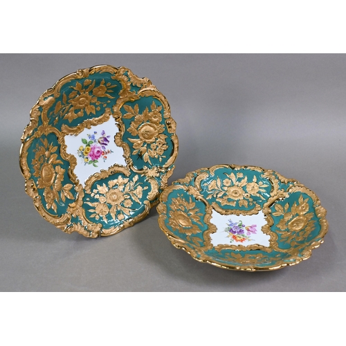 490 - A pair of early 20th century Meissen cabinet plates, painted with floral sprays within richly emboss... 