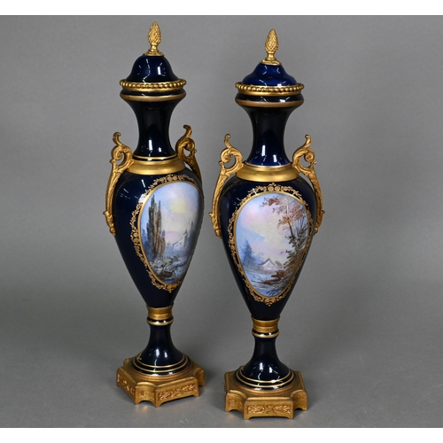 500 - A pair of late 19th century Sèvres porcelain garniture vases of slender baluster form with domed cov... 