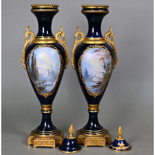 500 - A pair of late 19th century Sèvres porcelain garniture vases of slender baluster form with domed cov... 