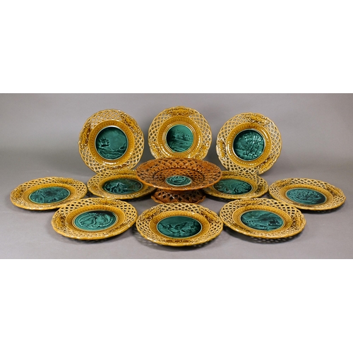 511 - A set of ten Rubelles (France) faience plates and matching comport with green-glazed pictorial centr... 