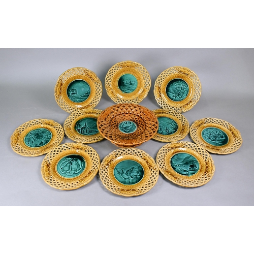 511 - A set of ten Rubelles (France) faience plates and matching comport with green-glazed pictorial centr... 