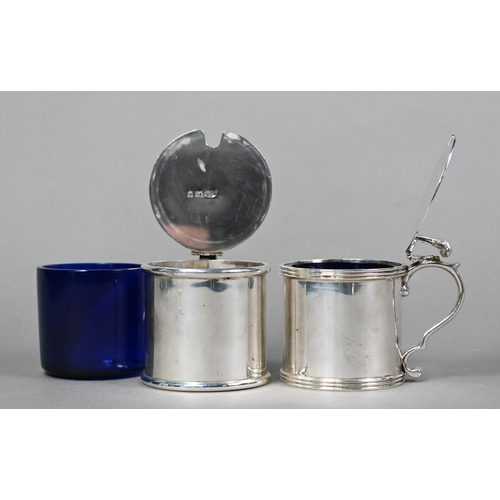 56 - A pair of heavy quality silver drum mustards with scrolling thumbpieces and blue glass liners, Rodne... 