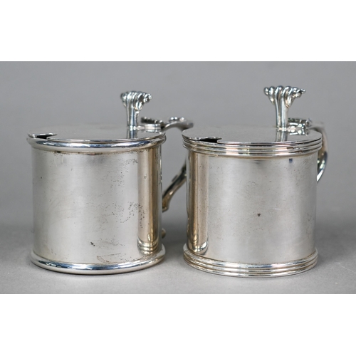 56 - A pair of heavy quality silver drum mustards with scrolling thumbpieces and blue glass liners, Rodne... 