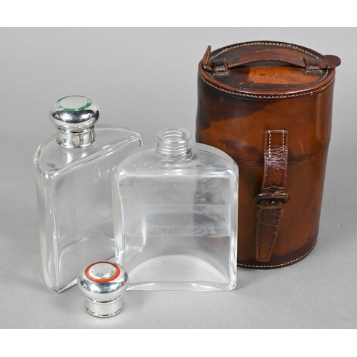 58 - An Edwardian cased pair of glass huntsman's spirit flasks of semi-circular form, the silver bun cove... 