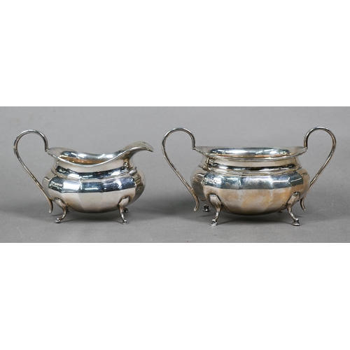 60 - A heavy quality silver four-piece tea service of oval form with vertical facets, on pad feet, with c... 