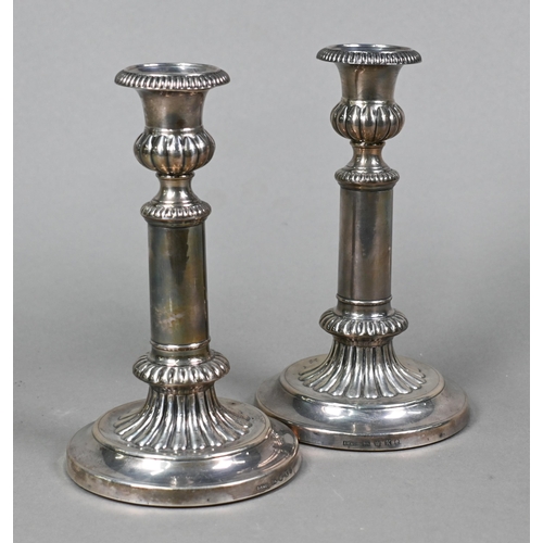 66 - A pair of George III loaded silver candlesticks with detachable grease-pans and fluted decoration, J... 