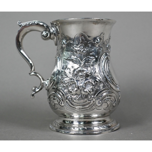 68 - A George III silver baluster mug, later embossed and chased with rococo scrolls and flowers, with sc... 