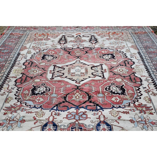 755 - A Turkish Zeigler design pale red and camel ground geometric design carpet, 435 cm x 303 cm, good ev... 