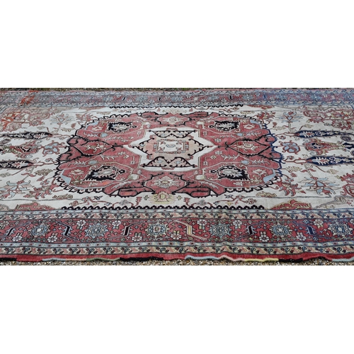 755 - A Turkish Zeigler design pale red and camel ground geometric design carpet, 435 cm x 303 cm, good ev... 