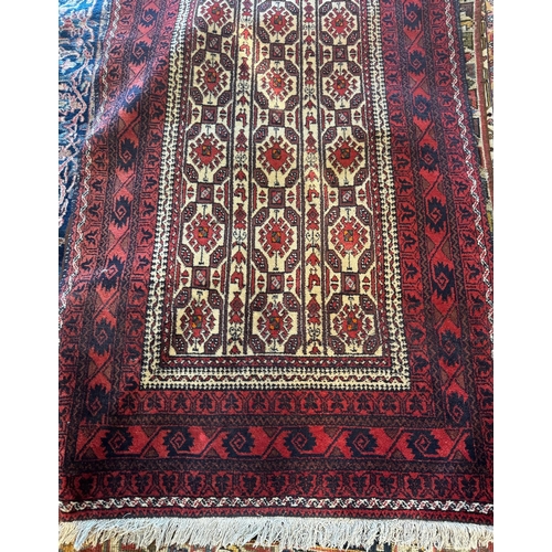 775 - A small Afghan Baluch rug with repeating geometric design on camel ground, red borders, 205 x 100 cm
