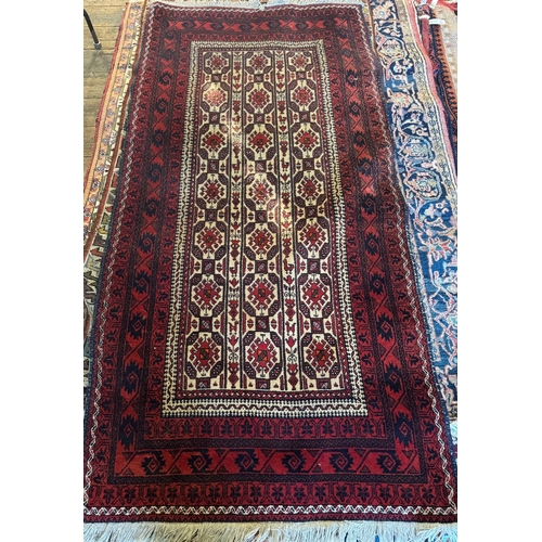 775 - A small Afghan Baluch rug with repeating geometric design on camel ground, red borders, 205 x 100 cm