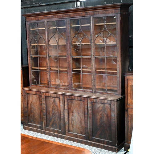 862 - A Regency flame mahogany library bookcase in the manner of Gillows, the moulded cornice over four go... 