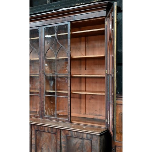 862 - A Regency flame mahogany library bookcase in the manner of Gillows, the moulded cornice over four go... 