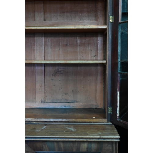 862 - A Regency flame mahogany library bookcase in the manner of Gillows, the moulded cornice over four go... 