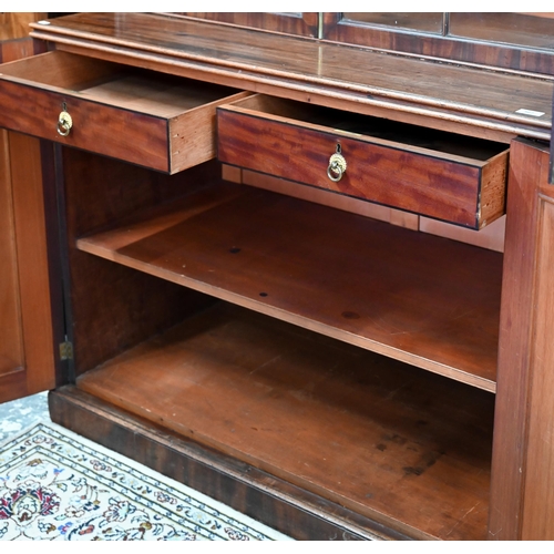 862 - A Regency flame mahogany library bookcase in the manner of Gillows, the moulded cornice over four go... 