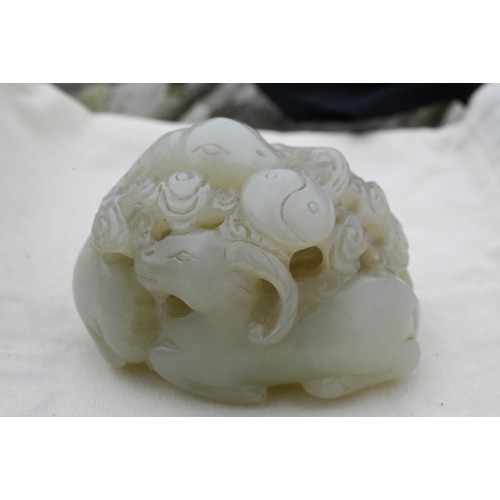 383 - An 18th century Chinese jade carving of three rams, sanyang, with swirling clouds and a yinyang symb... 