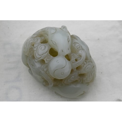 383 - An 18th century Chinese jade carving of three rams, sanyang, with swirling clouds and a yinyang symb... 