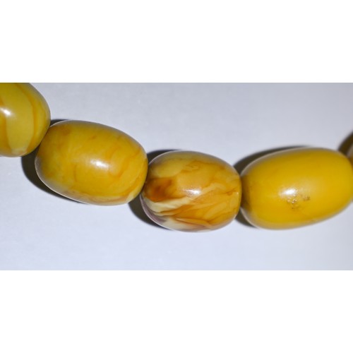 245 - A row of butterscotch amber beads on screw clasp, a/f, approx 30g