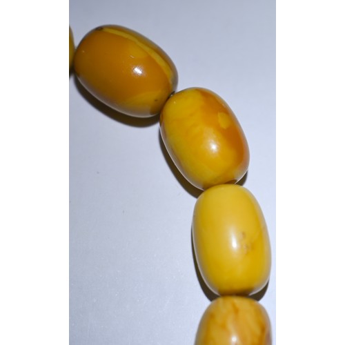 245 - A row of butterscotch amber beads on screw clasp, a/f, approx 30g