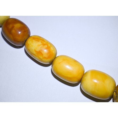 245 - A row of butterscotch amber beads on screw clasp, a/f, approx 30g