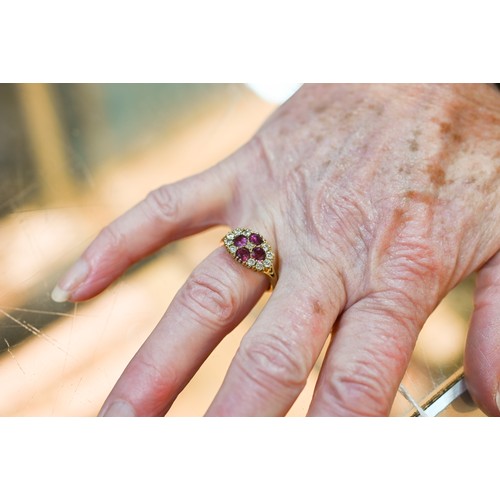 243 - An antique garnet and diamond cluster ring formed of four circular garnets with eleven diamonds arou... 