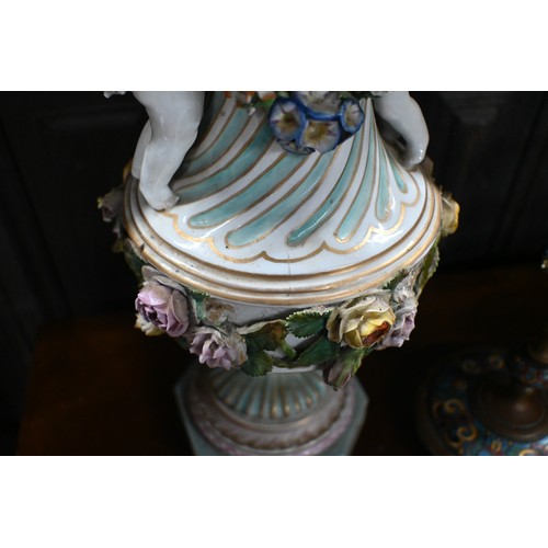 489 - A pair of 19th century Meissen garniture vases, with floral-encrusted covers above twin putti handle... 