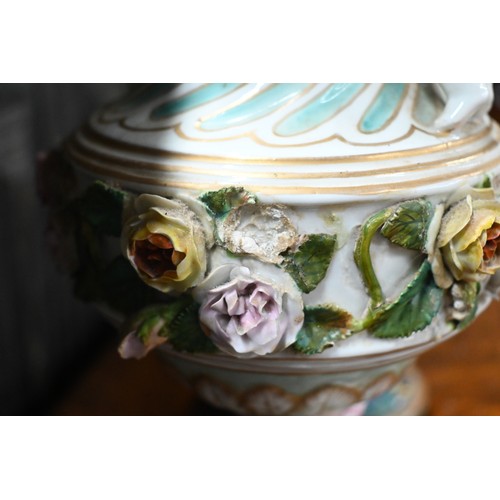 489 - A pair of 19th century Meissen garniture vases, with floral-encrusted covers above twin putti handle... 