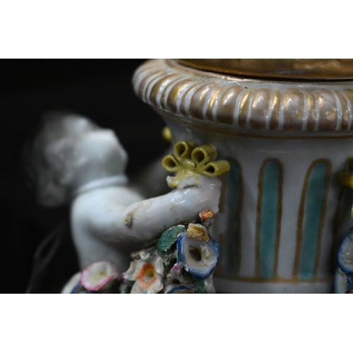 489 - A pair of 19th century Meissen garniture vases, with floral-encrusted covers above twin putti handle... 