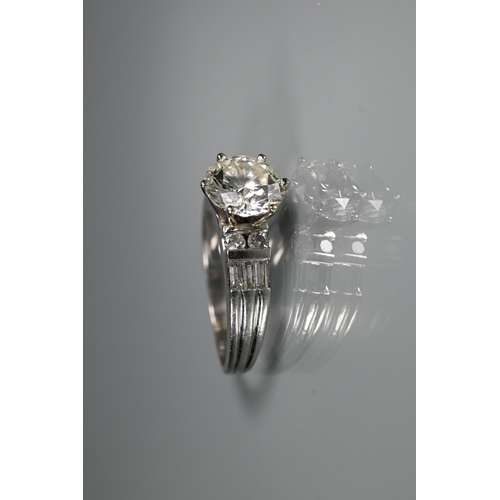 290 - A diamond ring, the central round brilliant cut stone with four round brilliant cut diamonds to each... 