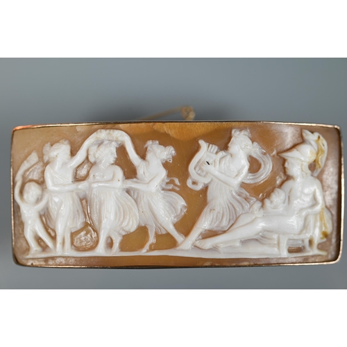 166 - A shell cameo rectangular brooch featuring a classical frieze of figures dancing to harp player, pla... 