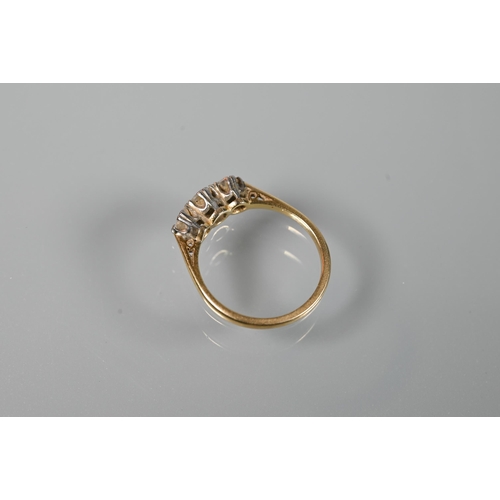 196 - A three-stone diamond ring, claw set in 18ct yellow gold and platinum setting, size L